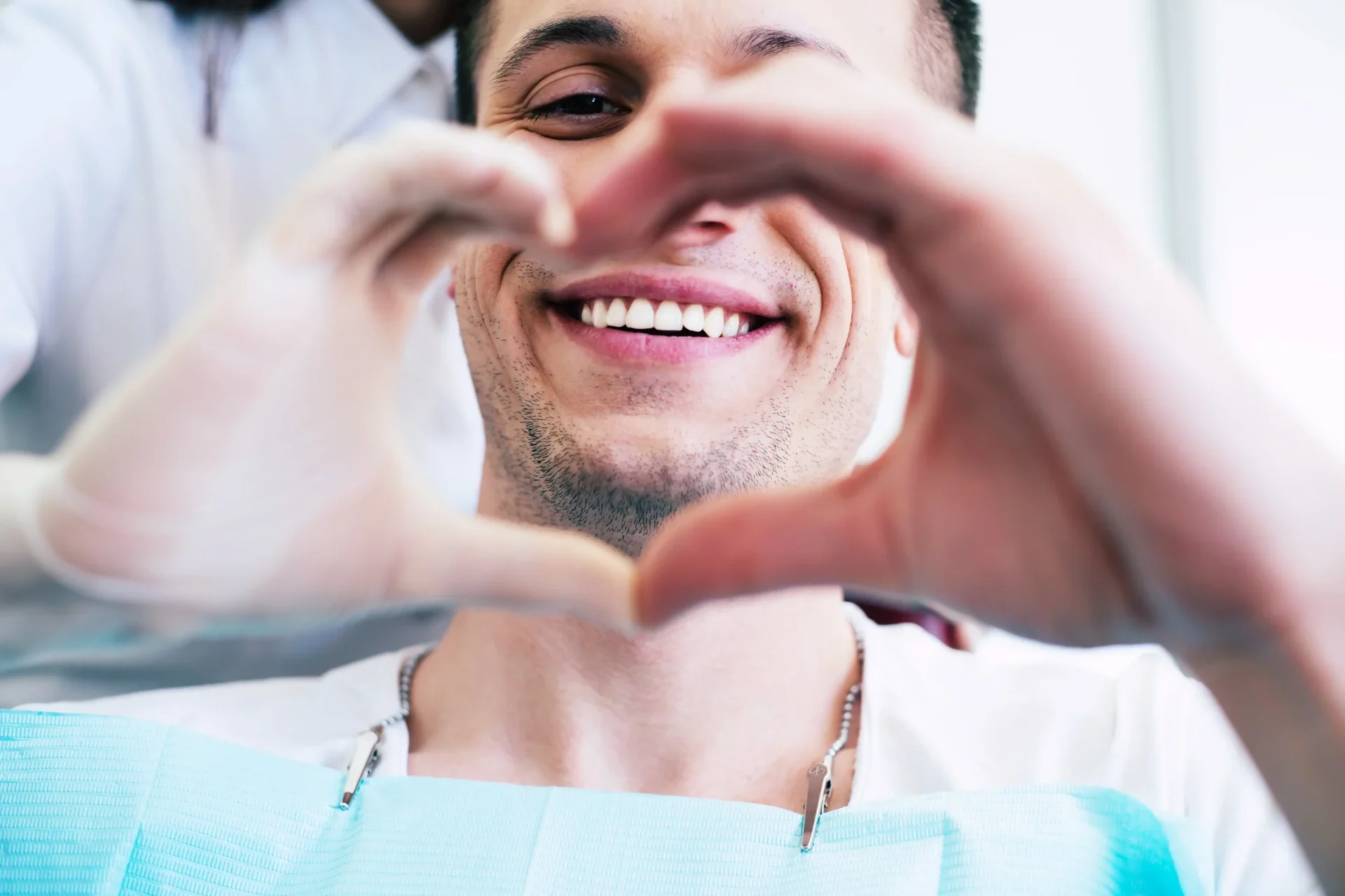 Dentist showing love sign with hands