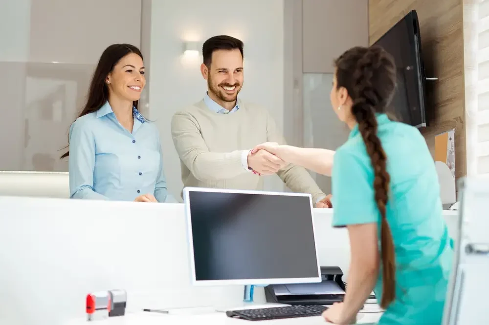 Dentists receptionist greeting clients