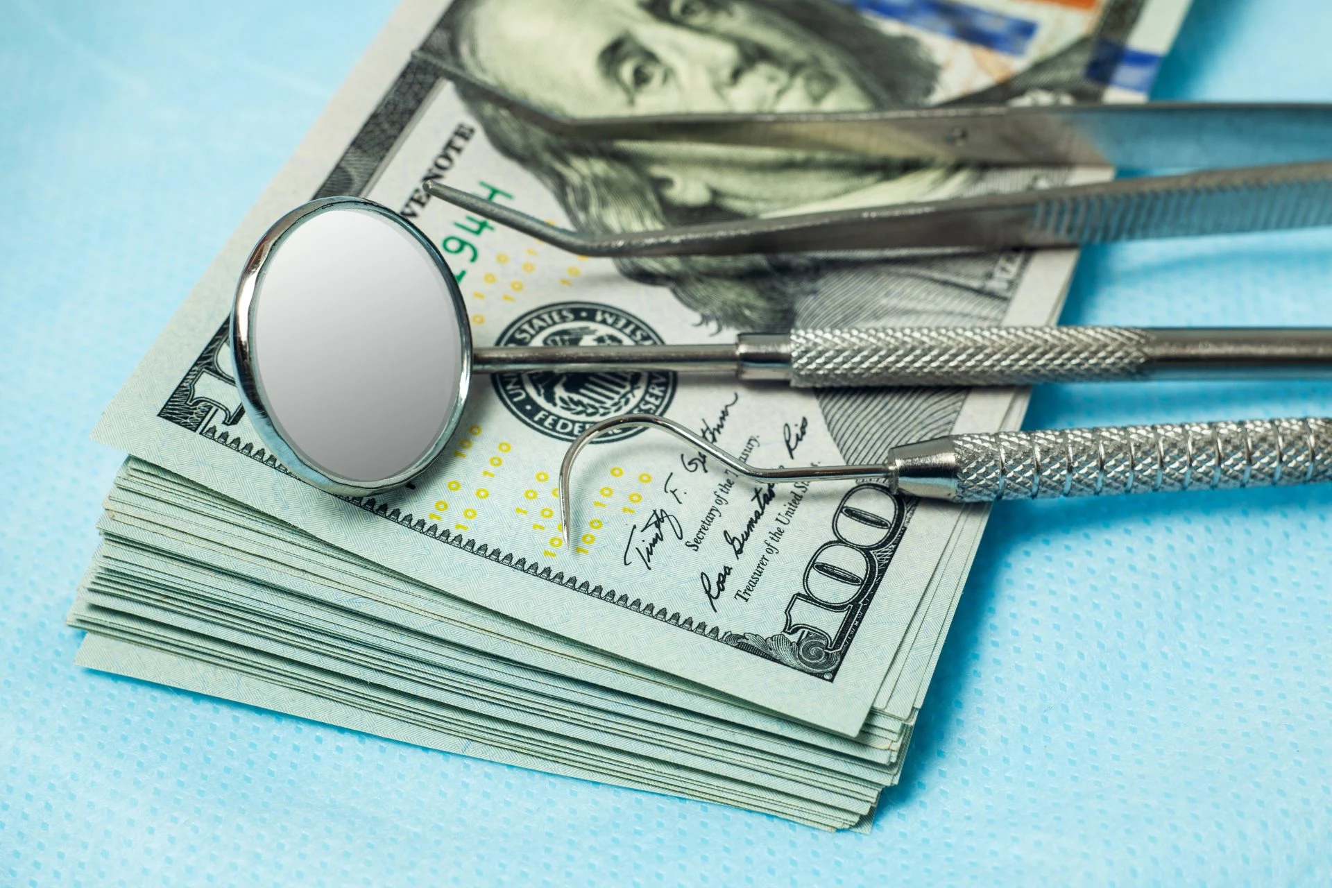 Dental tools on top of cash