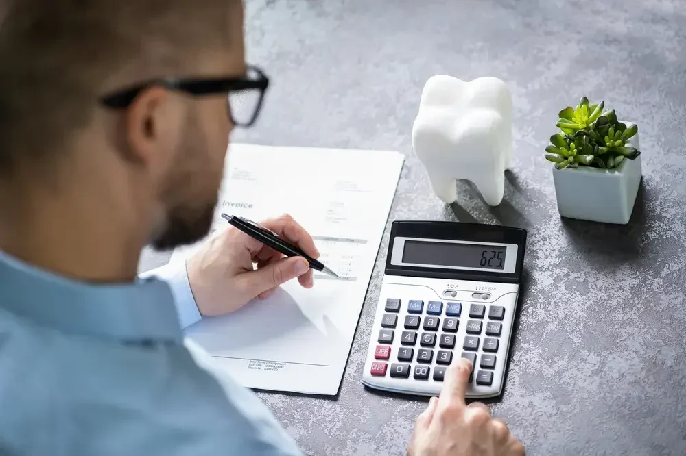 Dentist with a calculator